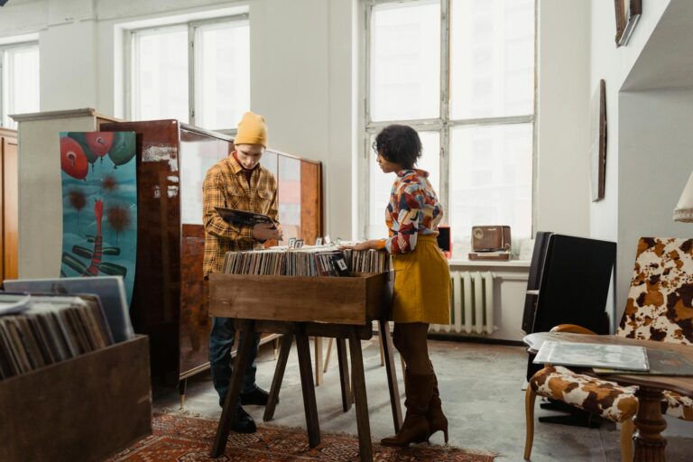Two young adults browsing a selection of vinyl records in a vintage-style store. A cozy retro atmosphere indoors.