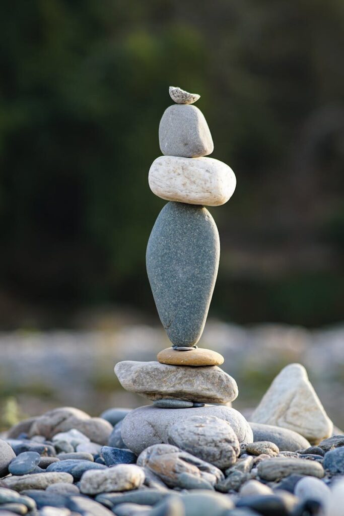 Tall stack of stones in serene outdoor setting representing balance and tranquility.