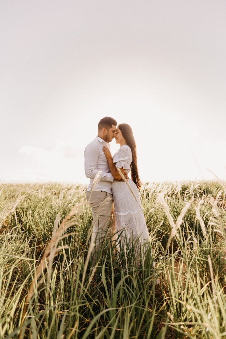 Young couple in love embracing in a sunny meadow, symbolizing romance and connection.